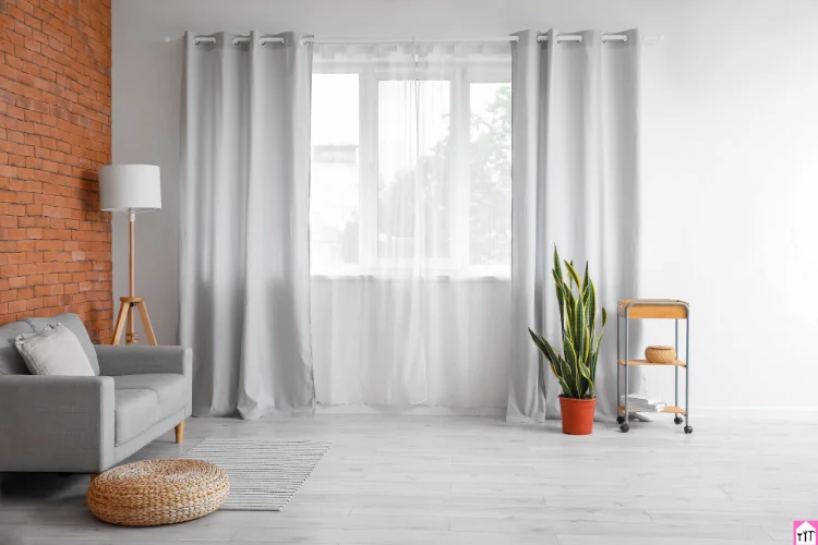 A modern window with light-filtering roller blinds, allowing soft sunlight to enter the room, creating a bright and airy atmosphere.