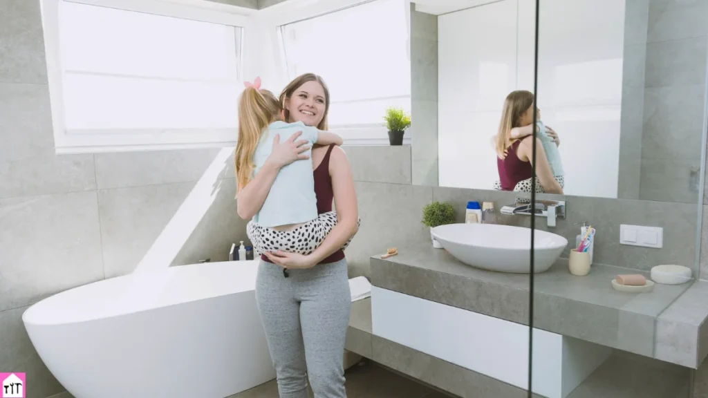 Bathroom renovation with modern vanity and bathtub as a mother holds her child in a bright, minimalist space